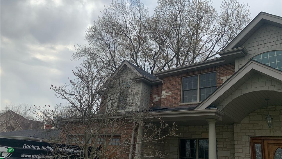 Newly installed roof and seamless gutters on a home in Arlington Heights, IL.