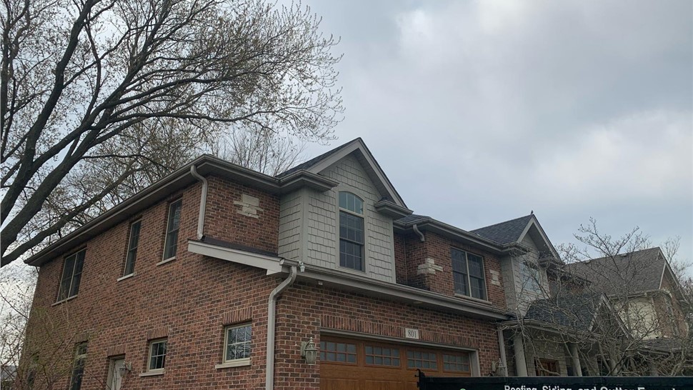 Newly installed roof and seamless gutters on a home in Arlington Heights, IL.