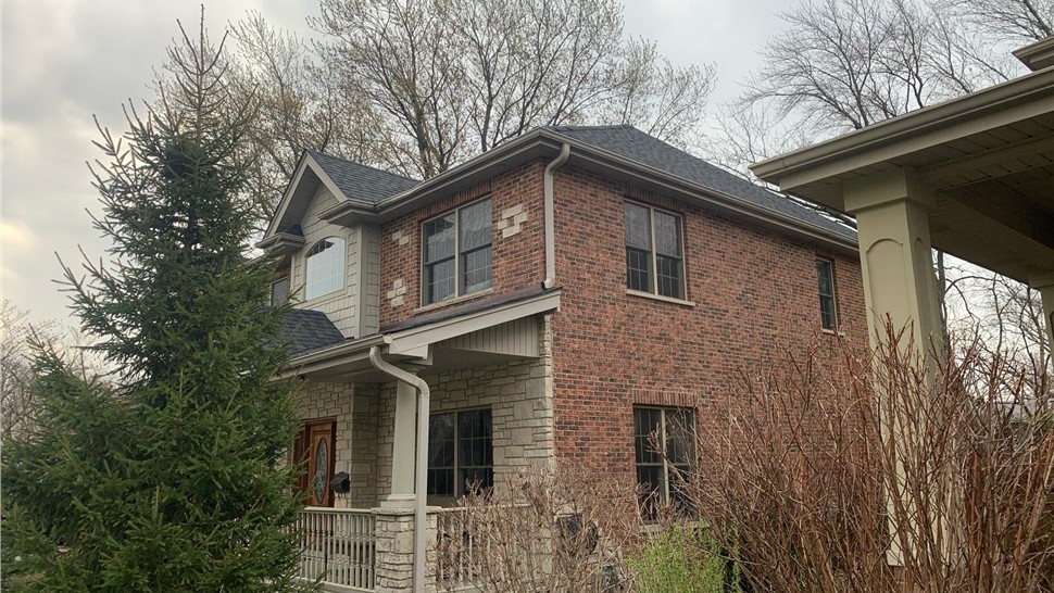 Newly installed roof and seamless gutters on a home in Arlington Heights, IL.