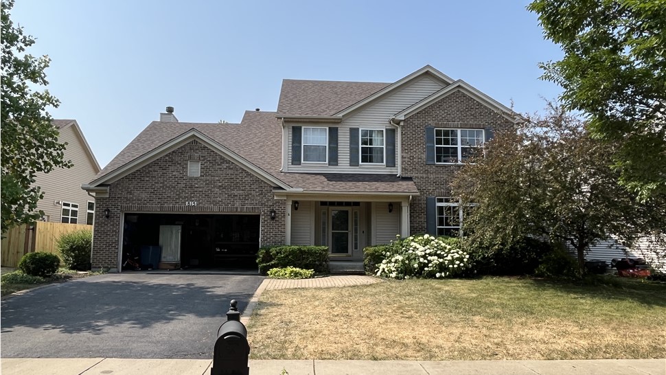Exquisite Symphony of Architectural Magnificence: TTLC, Inc. Adorns Oswego, IL with Owens Corning's Teak Shingle Roofing, Radiating Timeless Elegance and Unrivaled Endurance.