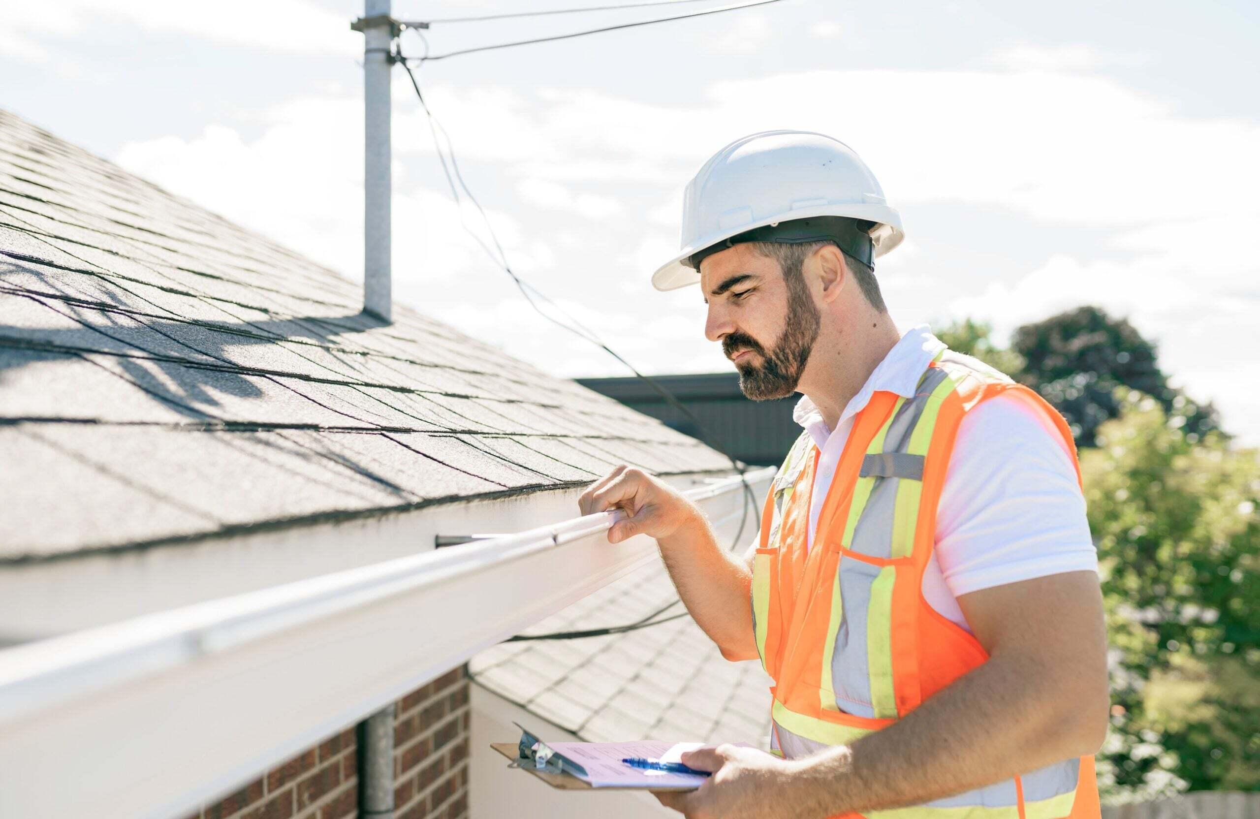 roofer completing inspection to put together roof replacement estimate