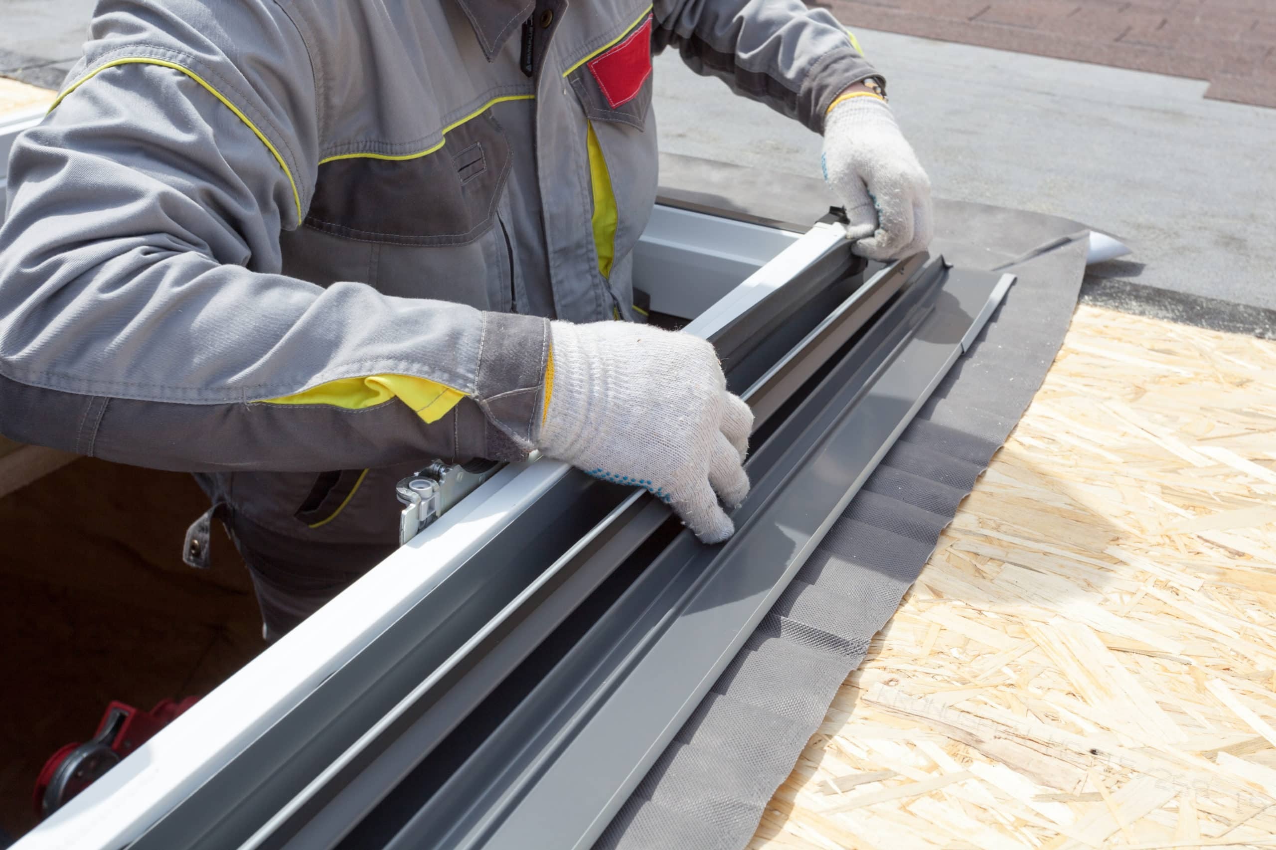 roofer attaching seal and flashing for skylight installation