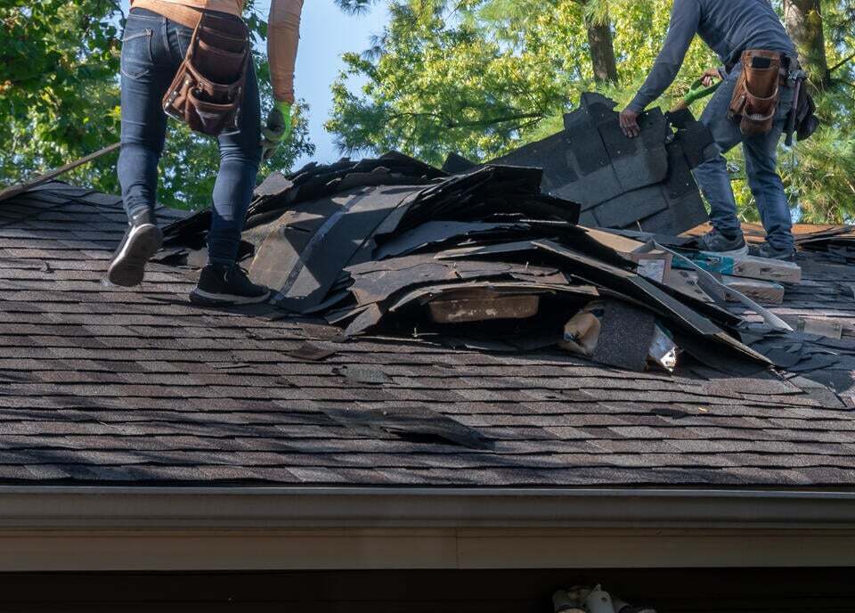 roof repair vs replacement-roof tear off happening by a crew for a replacement job