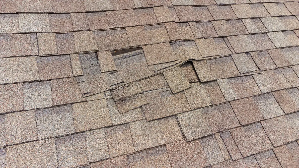 Loose shingles ready to tear off of roof - close up view