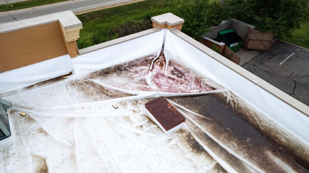 what types of commercial roofing systems are used in winona wi aerial view of damage on top of a TPO roof