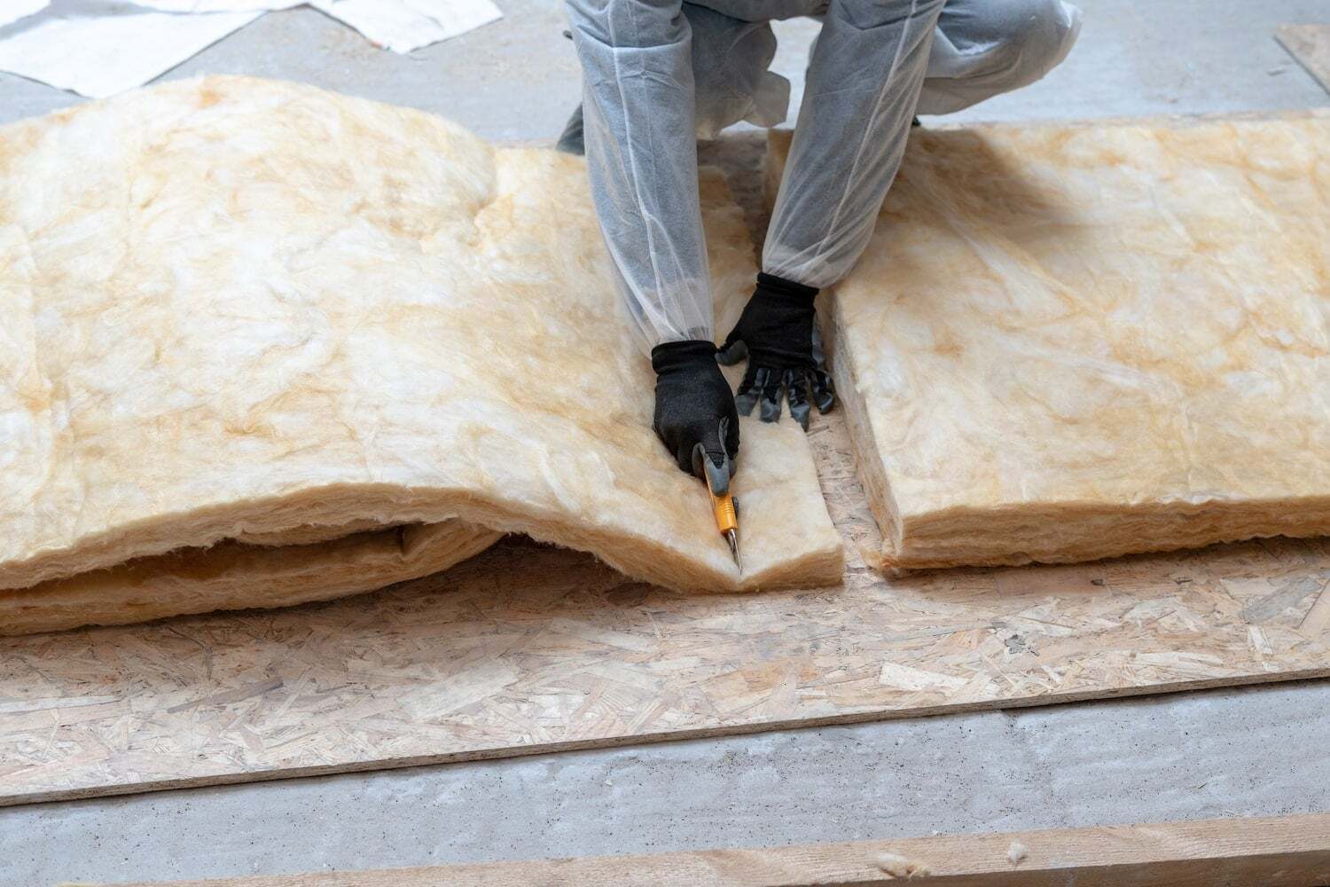 worker showing how to cut insulation