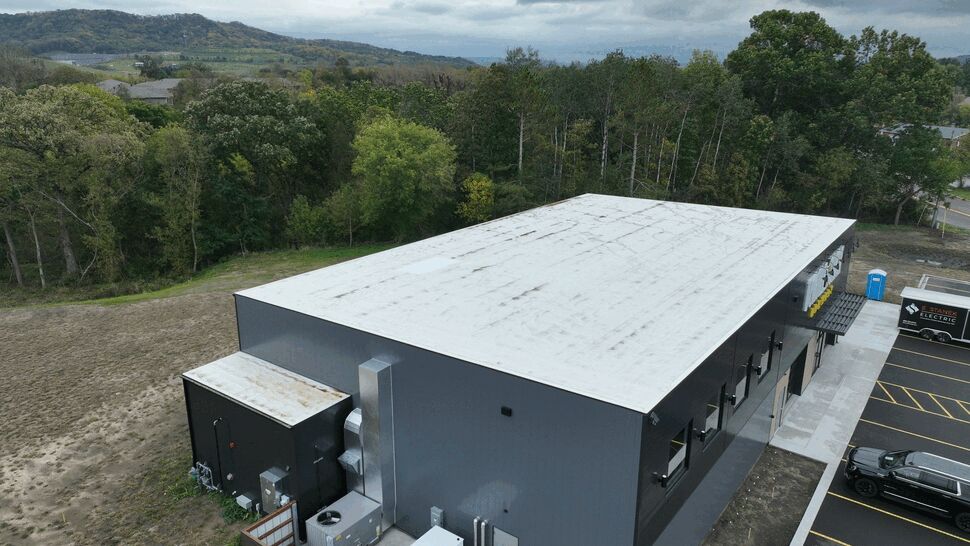 Commercial Roof Equipment View | First American Roofing & Siding Inc Aerial view of a white commercial roof and rooftop mechanical equipment.