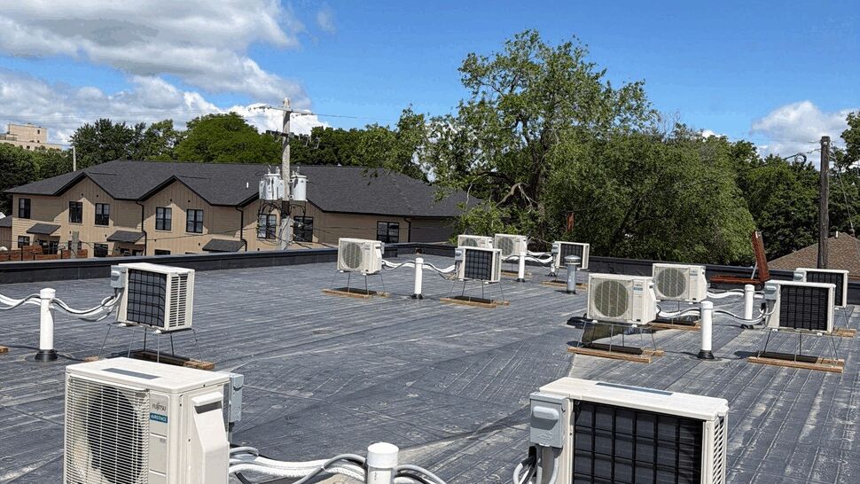 Flat commercial roof with multiple rooftop HVAC units