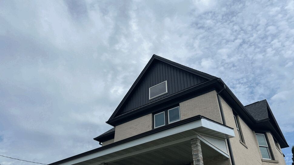 Completed Home Exterior Roofing | First American Roofing & Siding Inc Completed home exterior with dark roof, siding, gutters, and windows