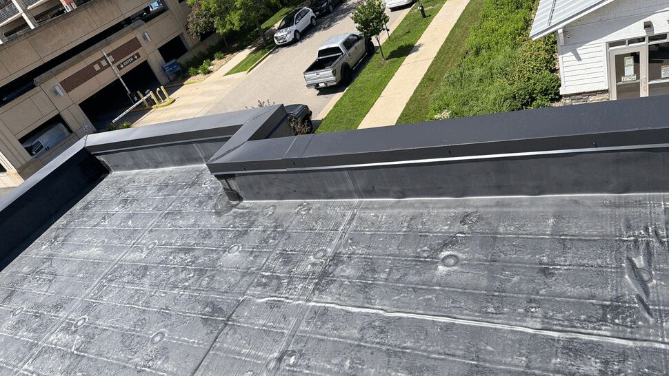 Close view of a finished flat roof with raised parapet edges