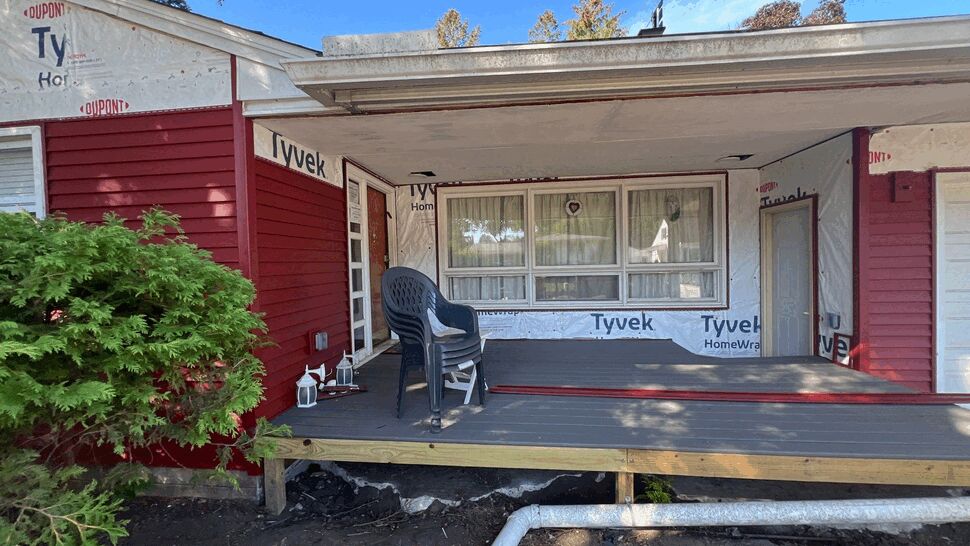 Front Porch Siding Renovation | First American Roofing & Siding Inc Front porch with Tyvek housewrap, red siding, windows, and white soffit under construction.