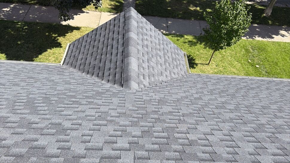 Gray Shingle Roof Overview | First American Roofing & Siding Inc Close view of a clean gray asphalt shingle roof above a residential neighborhood