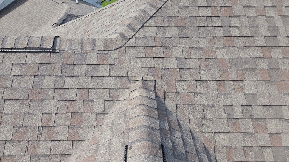 Ridge vent and shingle close-up | First American Roofing & Siding Inc Close-up of a shingle ridge and ridge vent on roof.
