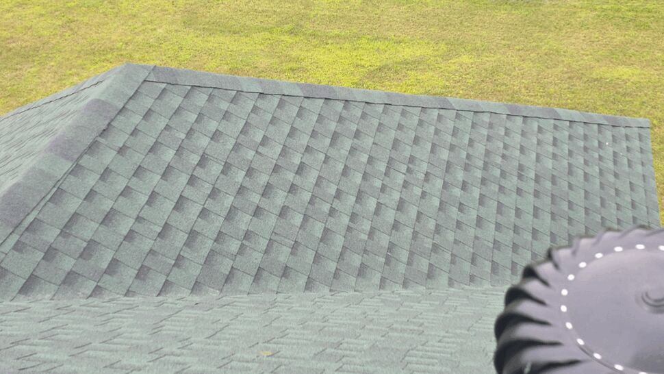 Roof Ridge and Vent Installation | First American Roofing & Siding Inc Overhead view of green shingles and roof ridge with attic vent