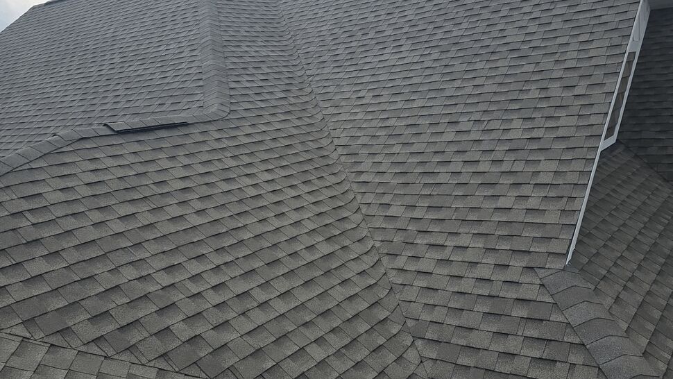 Roof valley shingle detail | First American Roofing & Siding Inc Close-up of intersecting roof planes and shingle valley.