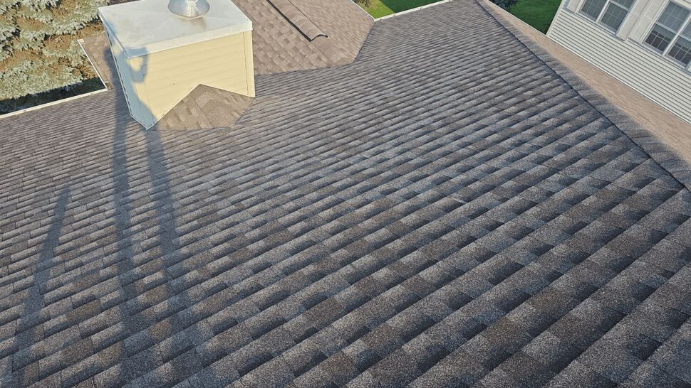 Roof Vent and Shingle Detail | First American Roofing & Siding Inc Shingle roof surface with metal roof vent and long shadows