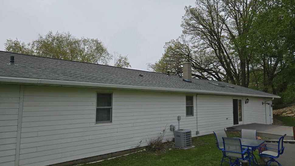 Updated Siding and New Roof with Gutters | First American Roofing & Siding Inc Single-story home with white horizontal siding, new gray shingle roof and gutters
