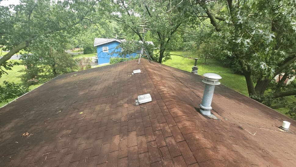 Worn Shingle Roof for Storm Assessment | First American Roofing & Siding Inc Worn brown shingle roof with vents and signs of aging and wear