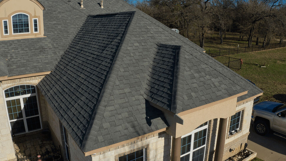 Aerial Residential Roof Inspection | US Metal Roofing Consortium Aerial view of a residential shingled roof and front windows with surrounding yard