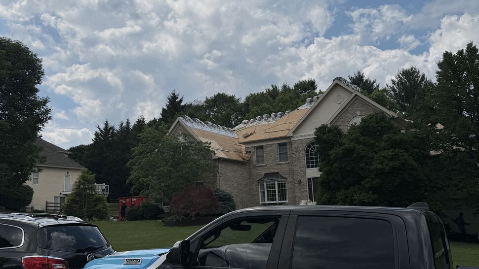 Paramount Home Solutions truck parked in front of a home with roof work underway