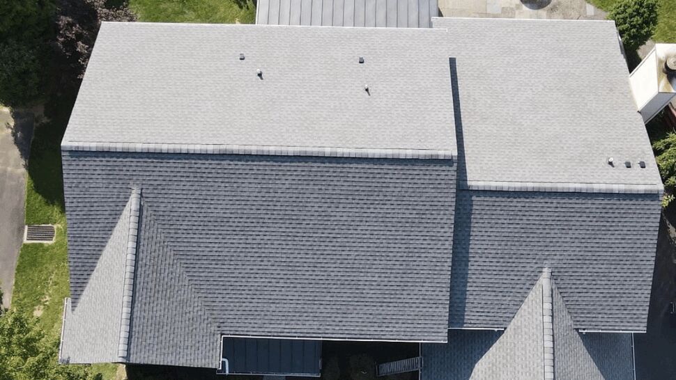 Top-down view of residential roof layout showing multiple roof planes and a metal patio roof section.