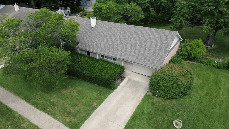 Front-facing aerial of roofline above garage and eaves with visible gutters.