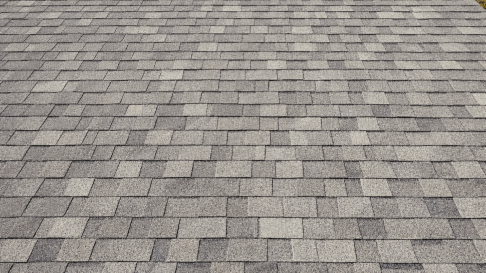 Close-up Asphalt Shingles with Vent | Tycos Roofing And Siding Inc Close-up of gray asphalt shingles with a metal roof vent on a sloped roof.