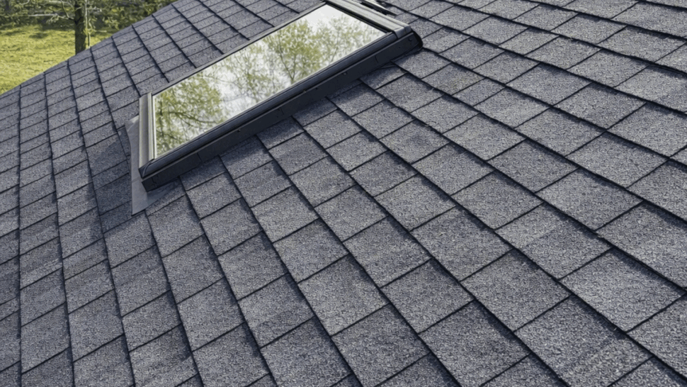 Asphalt shingle roof with a rectangular skylight installed