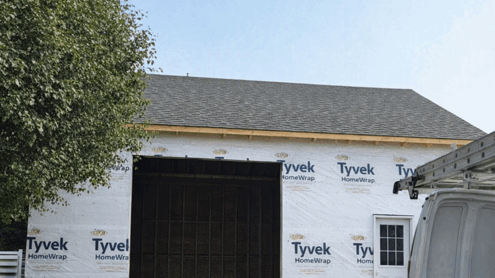 Garage Entry with Tyvek Wrap | Tycos Roofing And Siding Inc Garage opening and side entry door wrapped in Tyvek during construction.