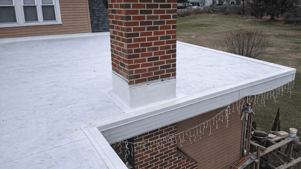 Chimney Flashing and Roof Edge | Tycos Roofing And Siding Inc Brick chimney on flat roof with flashing and roof edge details