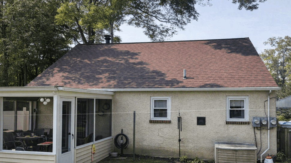 Backyard Four-Season Room and Roof | Tycos Roofing And Siding Inc Rear of house with enclosed porch and sloped shingle roof