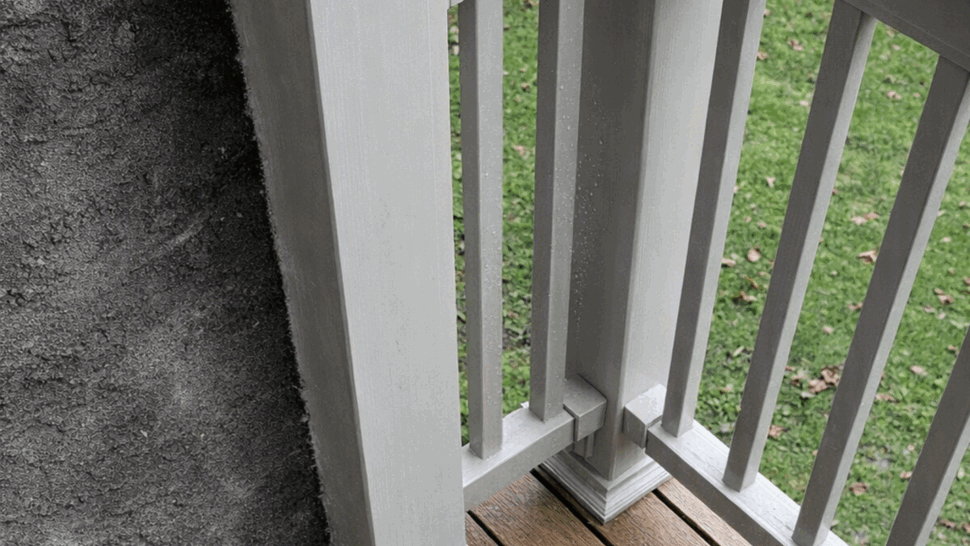 Close-up of decorative white deck railing posts and brown boards