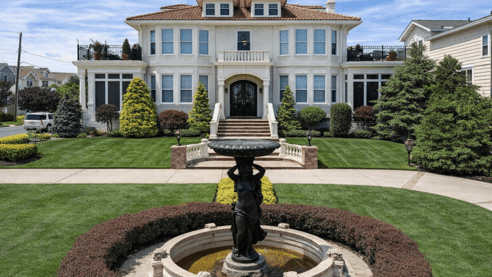 Front Mansion with Fountain and Updated Siding | Tycos Roofing And Siding Inc Front view of a large white house with ornate fountain and manicured lawn