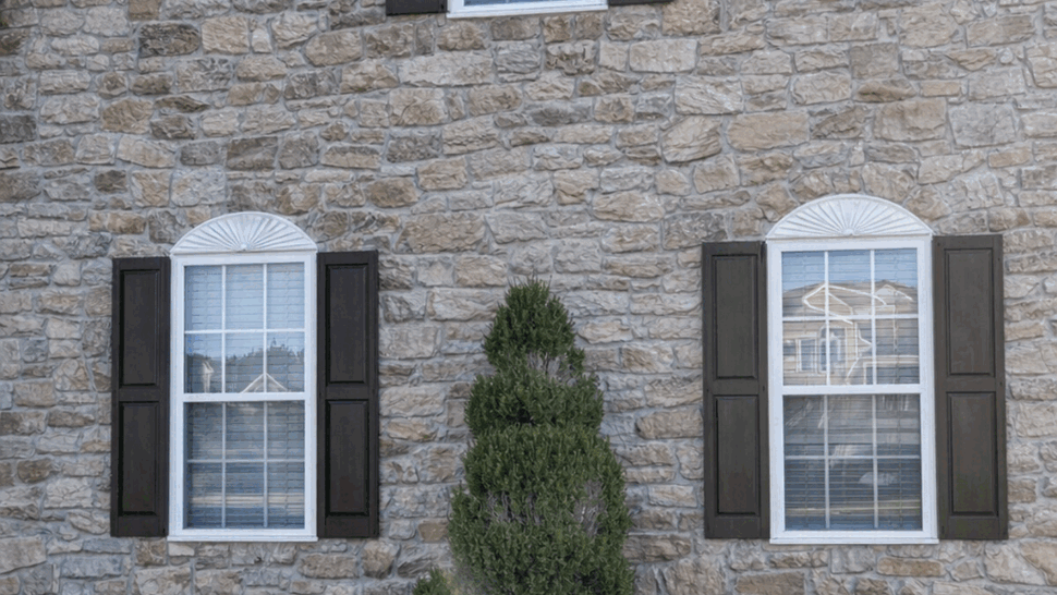 Stone Front Exterior with Windows | Tycos Roofing And Siding Inc Stone facade house front with three windows and decorative shutters