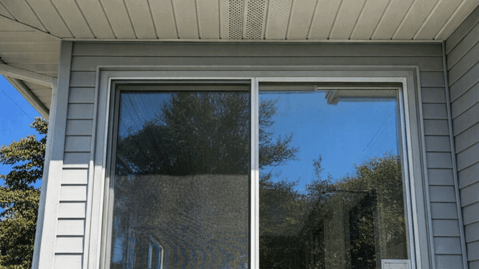 Large Exterior Window in Gray Siding | Tycos Roofing And Siding Inc Exterior large window in gray vinyl siding under a white soffit