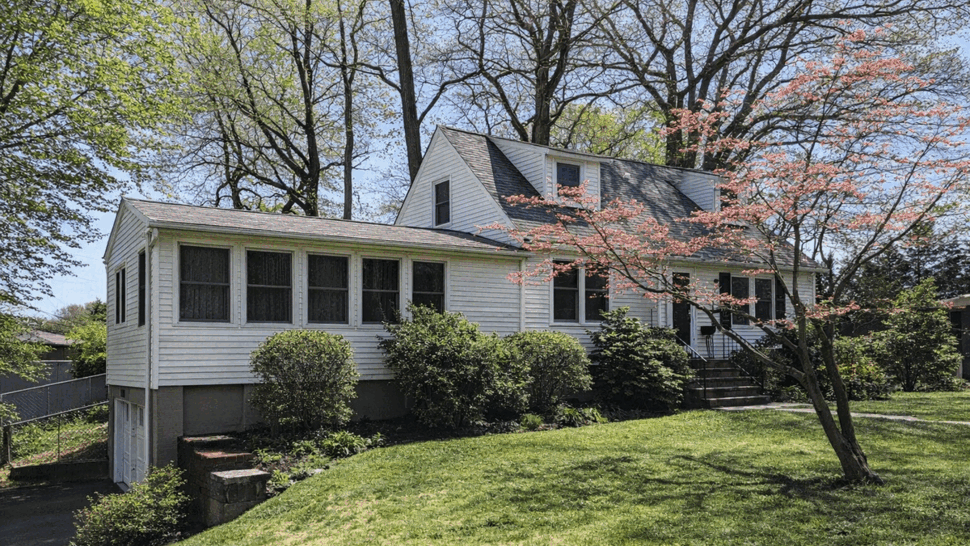 Front perspective showing an enclosed sunroom (four season room) with siding and windows