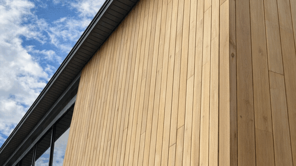 Cedar Siding and Soffit Detail | Tycos Roofing And Siding Inc Close-up of vertical cedar siding meeting the soffit and eave.
