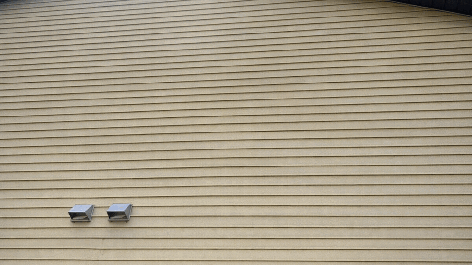 Light-colored horizontal siding on the side of a home