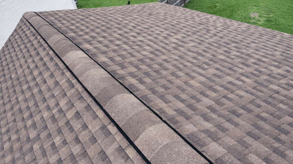 Roof-level view of overlapping asphalt shingles on a home