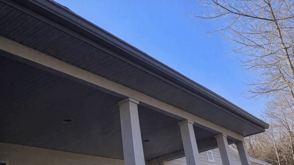 Covered porch underside with columns, soffit and gutter line.