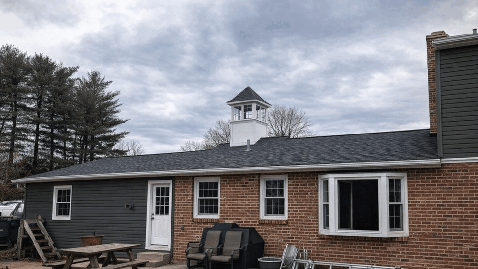 Back patio with windows, door, and outdoor furniture under a new roof.