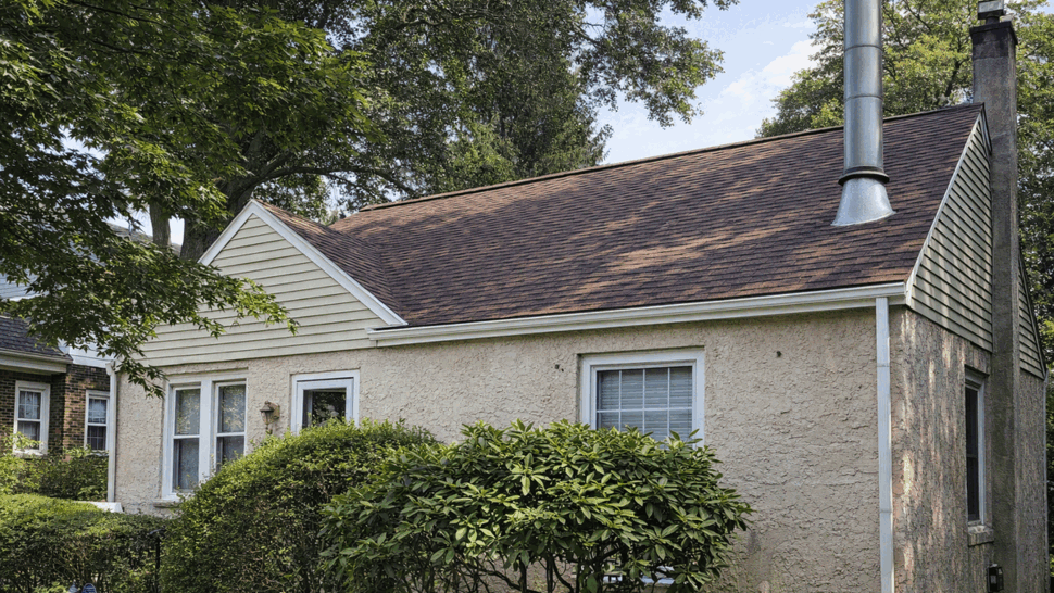 Side Roof and Gutters Inspection | Tycos Roofing And Siding Inc Side view of house roofline with gutters and double-hung windows