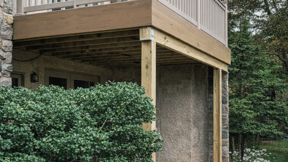 Elevated deck with white railings and wood-toned trim