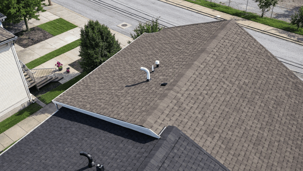 Angled Roofline Drone View | Tycos Roofing And Siding Inc Angled aerial shot of intersecting shingle rooflines and roof vents