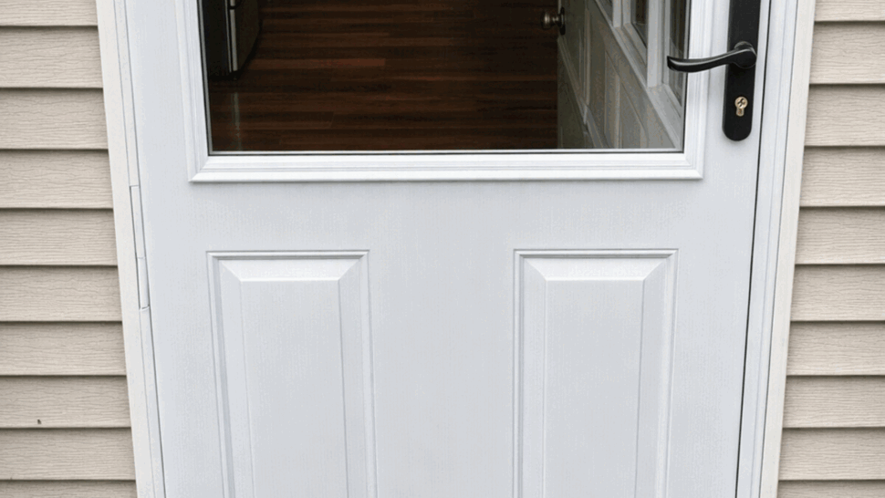 Close-up of white door threshold and adjacent wooden deck boards