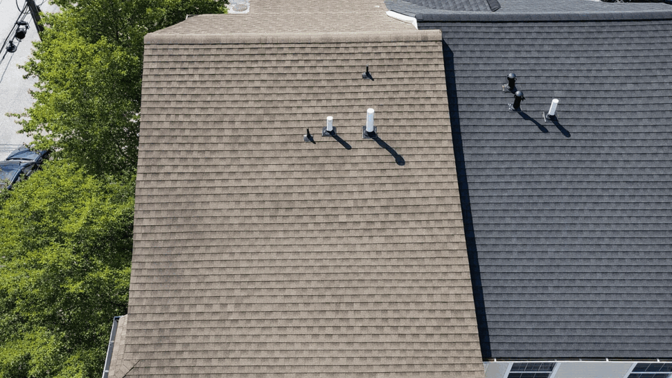 Aerial Roof Vents and Inspection View | Tycos Roofing And Siding Inc Top aerial view of a shingled roof with multiple vents and neighboring roofs