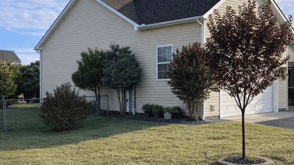 New Roof Installation on Residential Home | Tycos Roofing And Siding Inc Side view of home with newly shingled roof and clear blue sky
