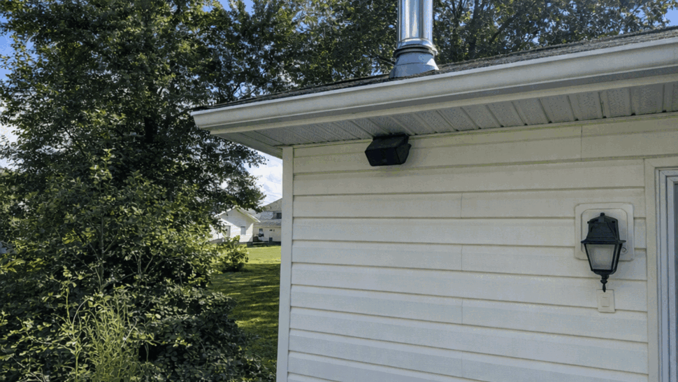 Blue painted deck with white siding and stainless chimney flue