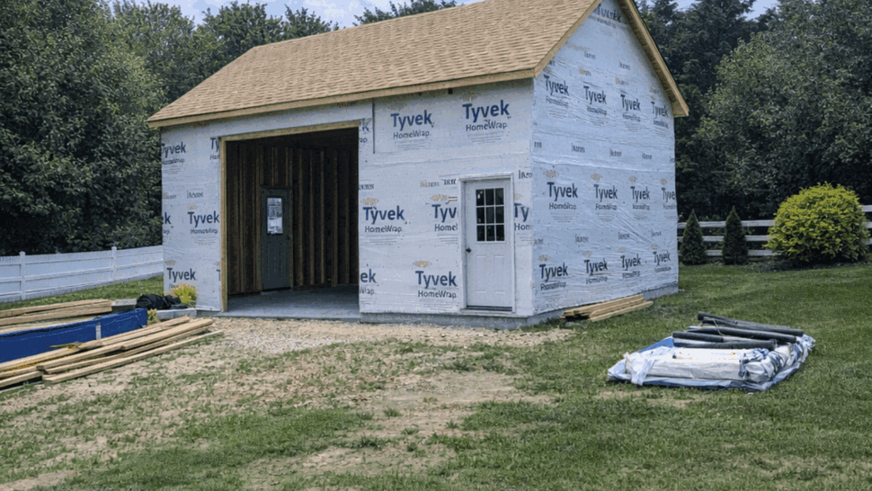 New Structure Wrapped for Siding | Tycos Roofing And Siding Inc New outbuilding wrapped in Tyvek with roof sheathing awaiting siding installation.