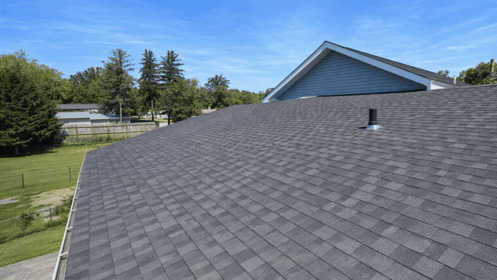 Asphalt roof slope with gutters | Tycos Roofing And Siding Inc Asphalt roof slope with plumbing vent and gutters visible along the eave